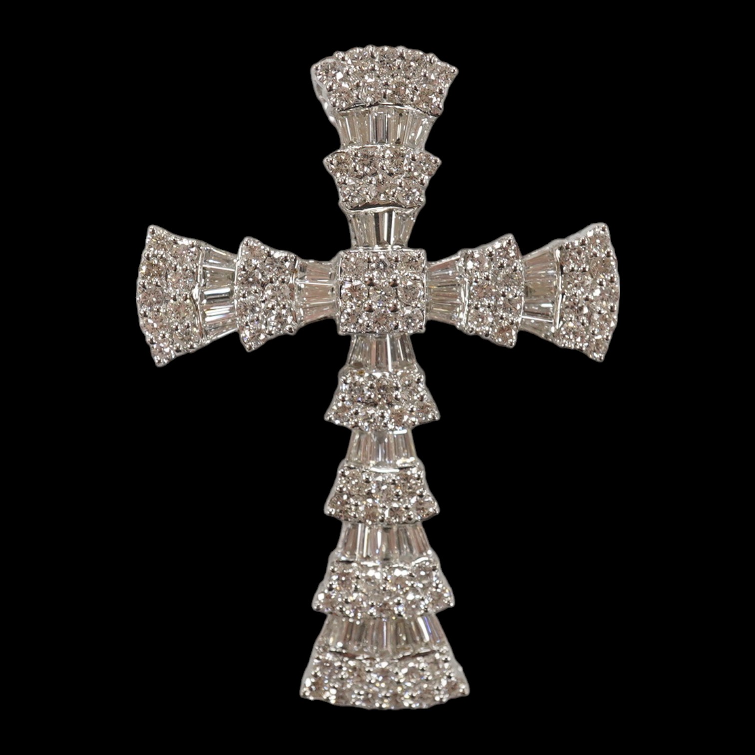 A modern 750 white metal, round and tapered baguette cut diamond cluster set cross pendant, 42mm, gross weight 7.2 grams. Condition - fair to good